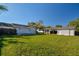Large backyard showcasing the lawn, house, carport, and trailer at 6316 S Richard Ave, Tampa, FL 33616