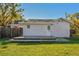 Home exterior featuring a wooden deck and spacious lawn at 6316 S Richard Ave, Tampa, FL 33616