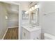 Bathroom featuring an adjacent bedroom and a vanity with decorative mirror and lights at 6316 S Richard Ave, Tampa, FL 33616