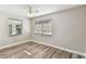 Bedroom featuring vinyl floors, two windows, and neutral colored walls at 6316 S Richard Ave, Tampa, FL 33616