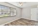 Bedroom featuring vinyl floors, a window with blinds, and neutral colored walls at 6316 S Richard Ave, Tampa, FL 33616