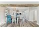 Dining room with wood-look floors, modern light fixture, and kitchen view at 6316 S Richard Ave, Tampa, FL 33616