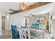 Cozy dining room area with reclaimed wood beam and modern lighting at 6316 S Richard Ave, Tampa, FL 33616