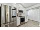 Modern kitchen featuring stainless steel appliances, white cabinets, and plenty of counter space at 6316 S Richard Ave, Tampa, FL 33616