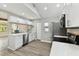 Well-lit kitchen featuring stainless steel appliances, modern cabinets, and a cozy breakfast bar at 6316 S Richard Ave, Tampa, FL 33616