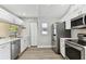 Updated kitchen features stainless steel appliances, stylish cabinetry and quartz countertops at 6316 S Richard Ave, Tampa, FL 33616