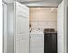 Convenient laundry closet featuring a full-size washer and dryer for in-home laundry convenience at 6316 S Richard Ave, Tampa, FL 33616