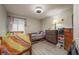 Cozy bedroom with wood floors and natural light is staged with cute decor at 6475 23Rd N St, St Petersburg, FL 33702