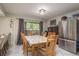 Bright dining room with a wooden table set and stainless steel refrigerator at 6475 23Rd N St, St Petersburg, FL 33702