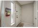 Clean entryway with neutral paint, a window for natural light, and a white front door at 6475 23Rd N St, St Petersburg, FL 33702