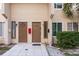 Townhome exterior featuring two front doors, clean tile patio, and a well-maintained facade at 6475 23Rd N St, St Petersburg, FL 33702