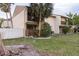 This two-story home is surrounded by lush greenery and has a charming outdoor area for relaxing at 6475 23Rd N St, St Petersburg, FL 33702