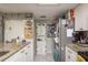 Functional kitchen featuring granite countertops, white cabinetry, and stainless steel appliances at 6475 23Rd N St, St Petersburg, FL 33702