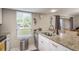Well-lit kitchen with granite countertops, stainless steel appliances, and a view to the exterior at 6475 23Rd N St, St Petersburg, FL 33702