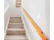 A bright stairway with wooden handrail leads to the next level of the home at 6475 23Rd N St, St Petersburg, FL 33702