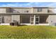 Townhome backyard featuring lawn and view of multiple AC units at 6709 Lake Rochester Ln, Gibsonton, FL 33534