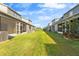 Townhome backyards featuring well-maintained lawn and views of multiple patios at 6709 Lake Rochester Ln, Gibsonton, FL 33534