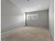 Neutral bedroom featuring a window providing natural light and neutral carpet at 6709 Lake Rochester Ln, Gibsonton, FL 33534