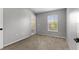 Neutral bedroom featuring a window providing natural light and neutral carpet at 6709 Lake Rochester Ln, Gibsonton, FL 33534