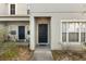Inviting entrance with well-manicured landscaping and a charming blue front door at 6709 Lake Rochester Ln, Gibsonton, FL 33534