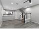 Open-concept living space with stairs, wood floors, and abundant natural light at 6709 Lake Rochester Ln, Gibsonton, FL 33534