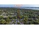 An aerial view showing the home's location amidst lush trees, waterways and a residential area at 8038 27Th N Ave, St Petersburg, FL 33710