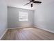 Bright bedroom with light-colored vinyl flooring and a window providing natural light at 8335 Paddlewheel St, Tampa, FL 33637