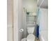 Bathroom with a toilet, shower, and storage shelves, providing practicality in a compact space at 8419 Laurelon Pl, Temple Terrace, FL 33637