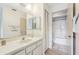 Bathroom featuring a long countertop vanity with a sink, large mirror, and adjacent toilet and shower area at 8419 Laurelon Pl, Temple Terrace, FL 33637