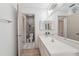 Bathroom featuring a wide countertop, double mirrors, and a view of the toilet and shower area at 8419 Laurelon Pl, Temple Terrace, FL 33637