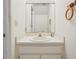 Bathroom features a sink, vanity, mirror, and a towel rack providing functionality in the space at 8419 Laurelon Pl, Temple Terrace, FL 33637