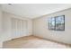 Bedroom with a closet and a window, features light wood floors and neutral paint at 8419 Laurelon Pl, Temple Terrace, FL 33637