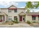 Charming townhome with a red front door, awning, and well-maintained landscaping at 8419 Laurelon Pl, Temple Terrace, FL 33637