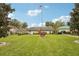 Well-maintained property featuring a lush lawn and mature landscaping at 8419 Laurelon Pl, Temple Terrace, FL 33637