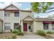 Charming townhome with a red front door, awning, and well-maintained landscaping at 8419 Laurelon Pl, Temple Terrace, FL 33637