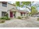 A row of tan townhomes featuring red awnings and neatly kept landscaping at 8419 Laurelon Pl, Temple Terrace, FL 33637