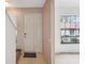 Bright foyer with a staircase, a white front door, and a large window at 8419 Laurelon Pl, Temple Terrace, FL 33637