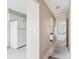 Hallway with a refrigerator near the kitchen and patio at 8419 Laurelon Pl, Temple Terrace, FL 33637