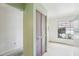 Hallway with wooden closet door and large window at 8419 Laurelon Pl, Temple Terrace, FL 33637