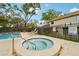 Relaxing hot tub situated next to community pool and lounge seating at 8419 Laurelon Pl, Tampa, FL 33637