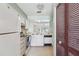 Cozy kitchen featuring white appliances, ample counter space, and natural light at 8419 Laurelon Pl, Tampa, FL 33637