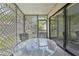 Relaxing screened patio featuring a glass table and comfortable cushioned chairs for enjoying the outdoors at 8419 Laurelon Pl, Temple Terrace, FL 33637