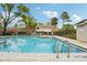 Inviting community pool with ample space and seating under a sunny sky at 8419 Laurelon Pl, Temple Terrace, FL 33637