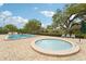 An inviting pool and relaxing hot tub with lounge seating and shade at 8419 Laurelon Pl, Temple Terrace, FL 33637
