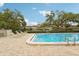 Community swimming pool with paved patio, mature trees and lounge seating at 8419 Laurelon Pl, Temple Terrace, FL 33637