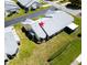 Aerial view of house showing roof and surrounding lawn, located in a golf community at 908 Rosewood Ln, Palm Harbor, FL 34684