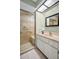 Bathroom featuring a glass enclosed shower, tile flooring, and a modern vanity at 908 Rosewood Ln, Palm Harbor, FL 34684