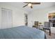 Bedroom with a comfortable queen bed, soft carpet, a ceiling fan, with open door to living space at 908 Rosewood Ln, Palm Harbor, FL 34684