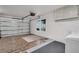 Garage with storage, washer and dryer hookups, and partially carpeted for multiple uses at 908 Rosewood Ln, Palm Harbor, FL 34684