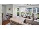 Kitchen with a view to nook with round glass table and chairs in front of windows at 908 Rosewood Ln, Palm Harbor, FL 34684